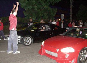 Race starters and observers are often positioned very close to the racing vehicles, putting themselves at considerable risk of injury. emCredit SDStreetracing.com
